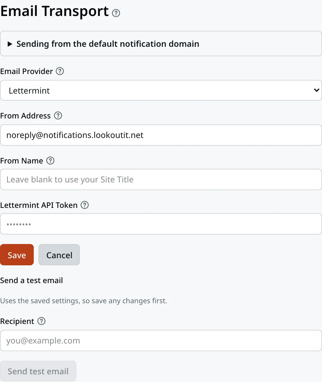 The Email Transport screen. A folded line at the top reads Sending from the default notification domain. Below it, Email Provider reads Lettermint, From Address holds our shared sending address, From Name is blank, and the Lettermint API Token box shows dots instead of a value. Save and Cancel sit under them. Last comes Send a test email, with a Recipient box and a Send test email button.